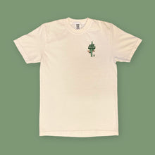Load image into Gallery viewer, Opal Atlas desert road trip T-shirt in cream, shown flat with a small cactus sign graphic on the front.