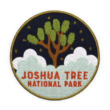 Load image into Gallery viewer, Joshua Tree National Park souvenir patch with clouds and Joshua Tree embroidered on navy blue felt.
